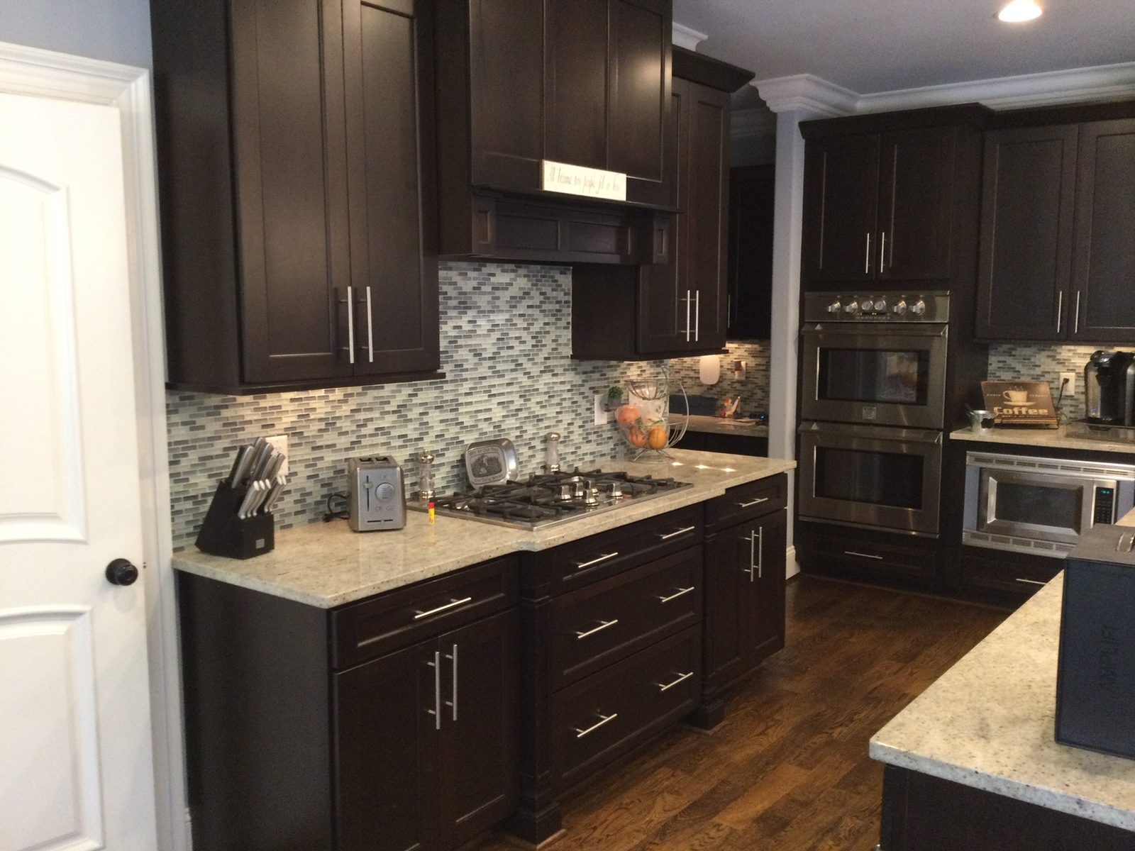 Kitchen with dark espresso-stained cabinets before Roca's Painters refinished them