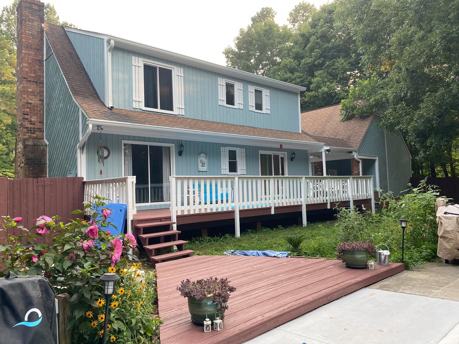 The same home after exterior repair, priming, and a full repaint