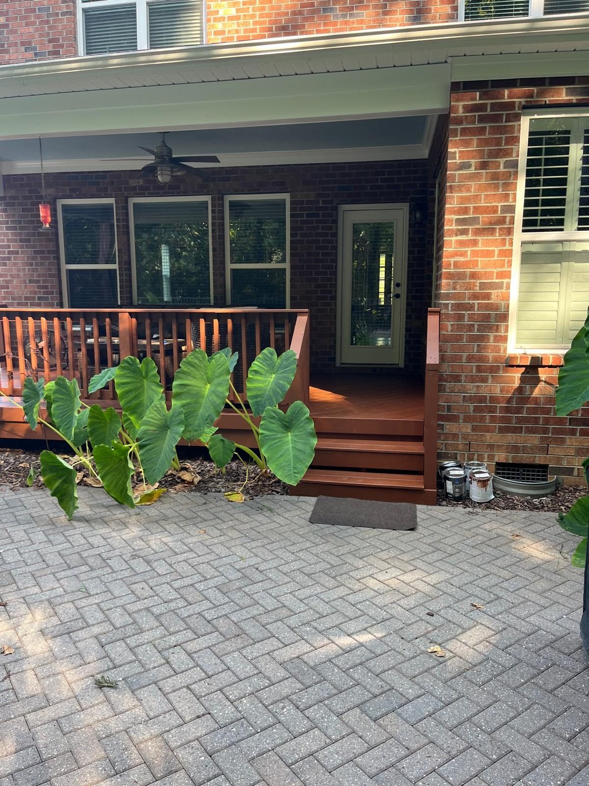 Brick home entry with wood porch steps stained a warm tone