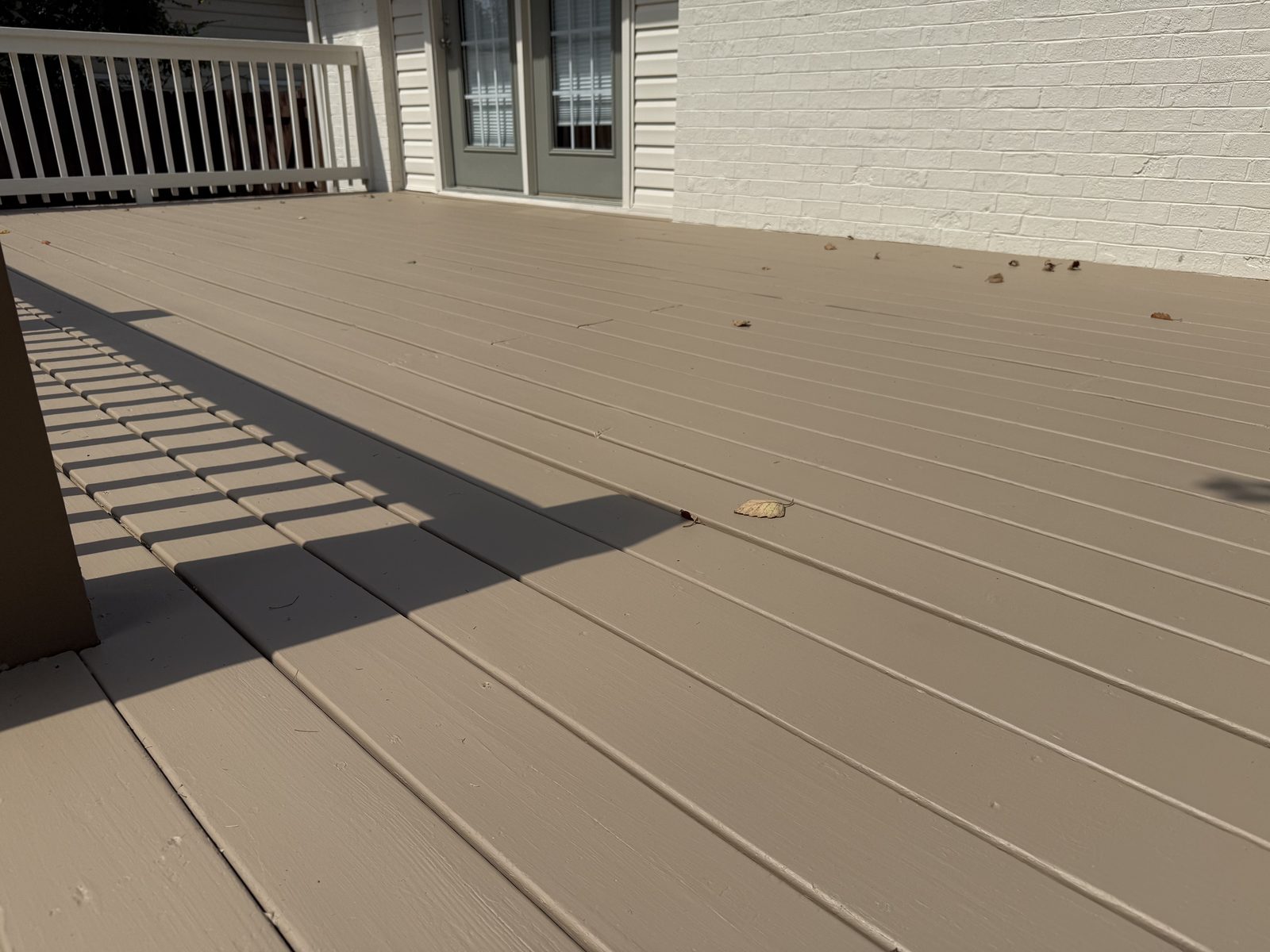 Close view of freshly painted tan deck boards