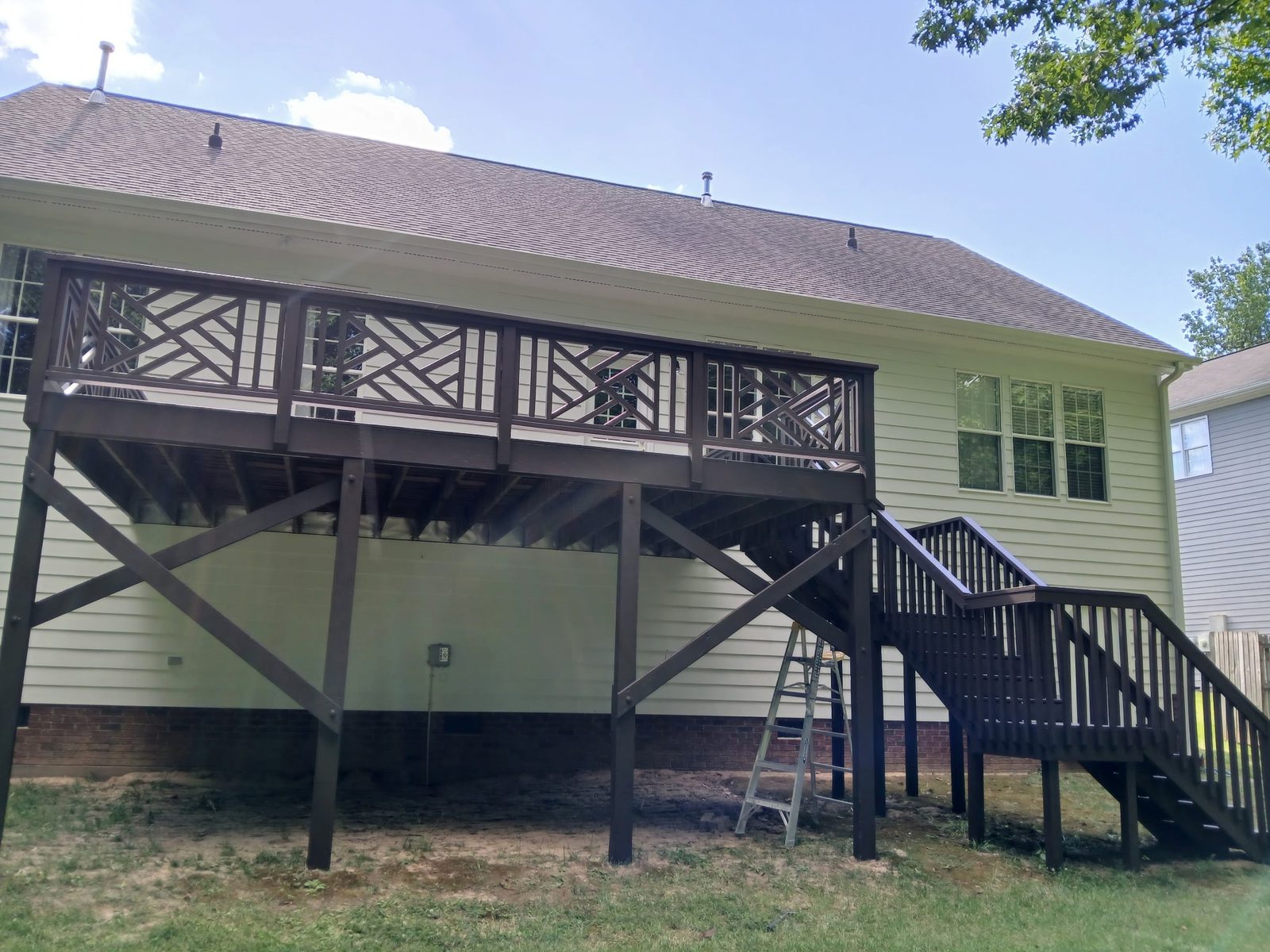Elevated deck with dark stained boards and railings