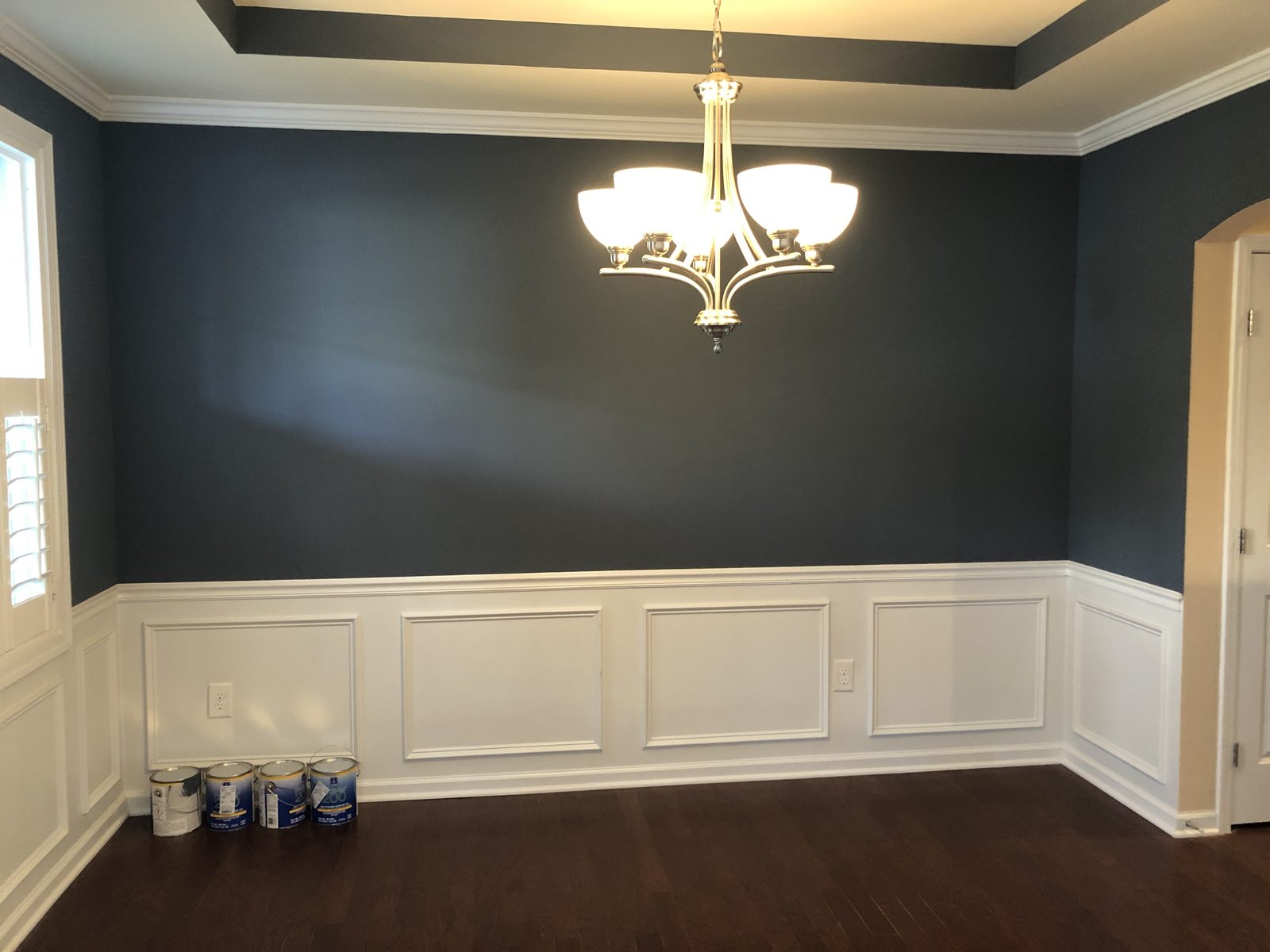 Dining room painted in a deep navy accent color