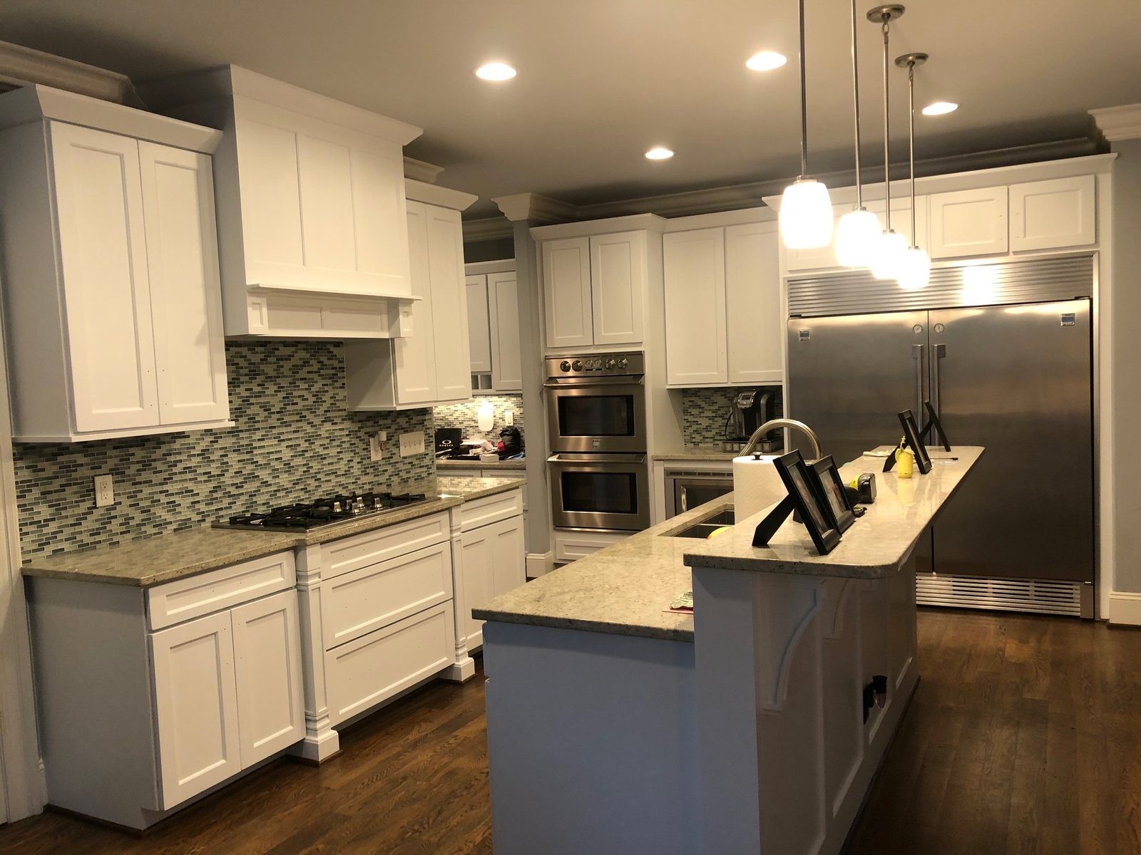 The same kitchen after Roca's Painters sprayed the cabinets a smooth white finish