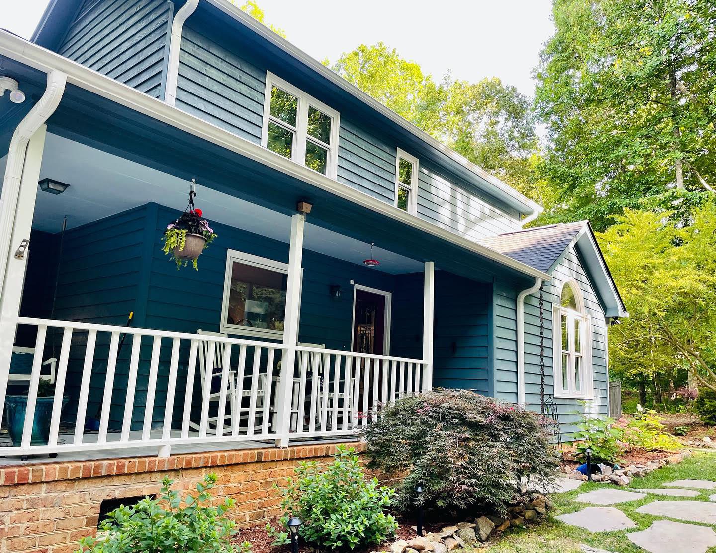 Blue siding and white porch railings after exterior painting