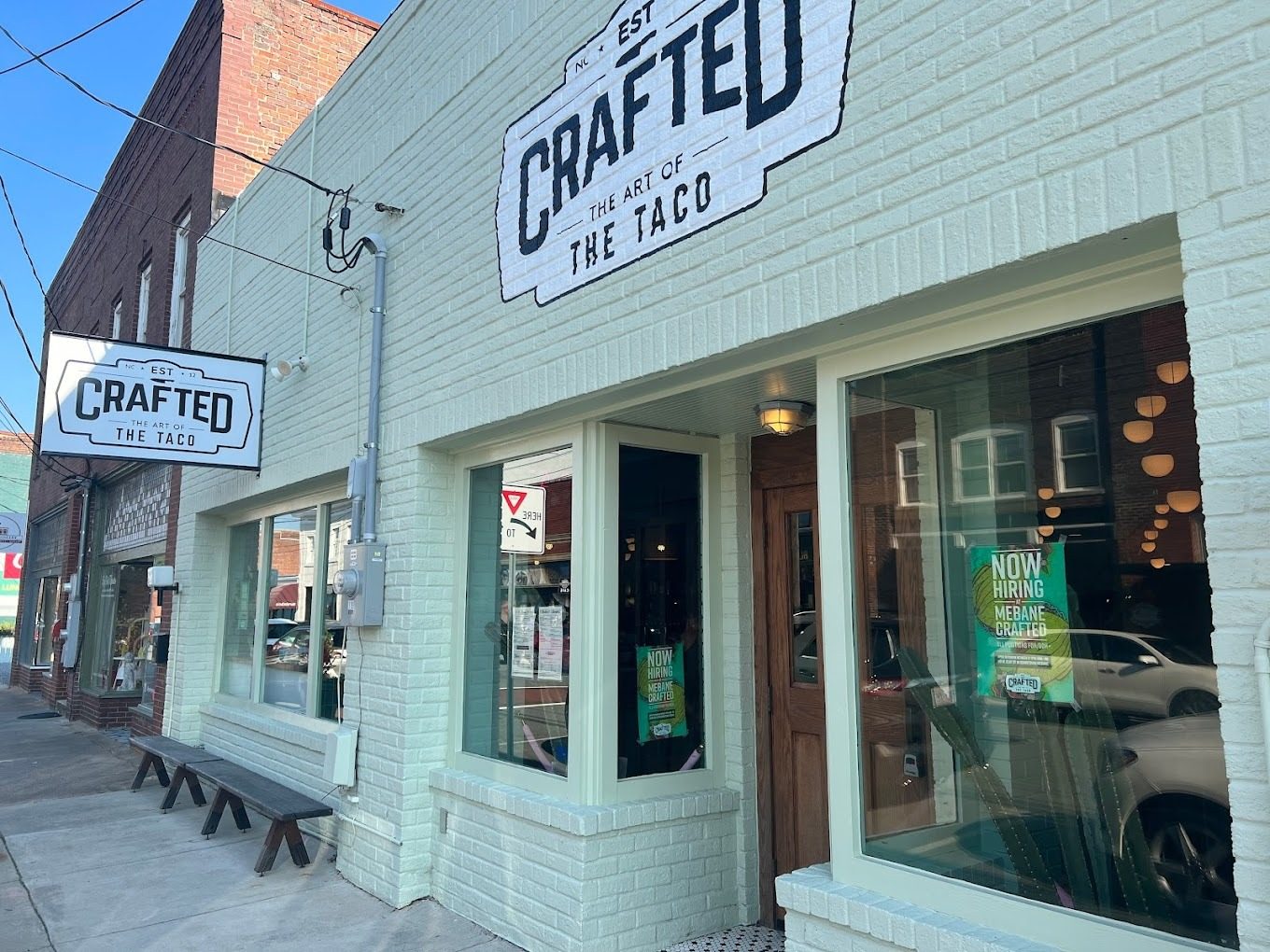 Downtown Mebane restaurant storefront with newly painted brick facade