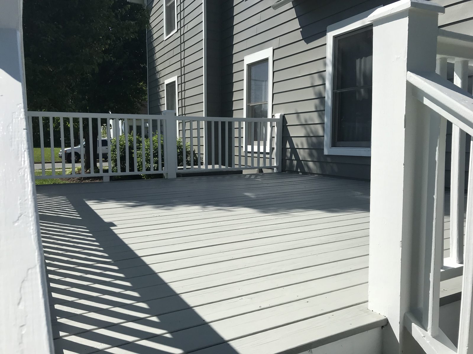 Deck floor painted gray next to gray siding