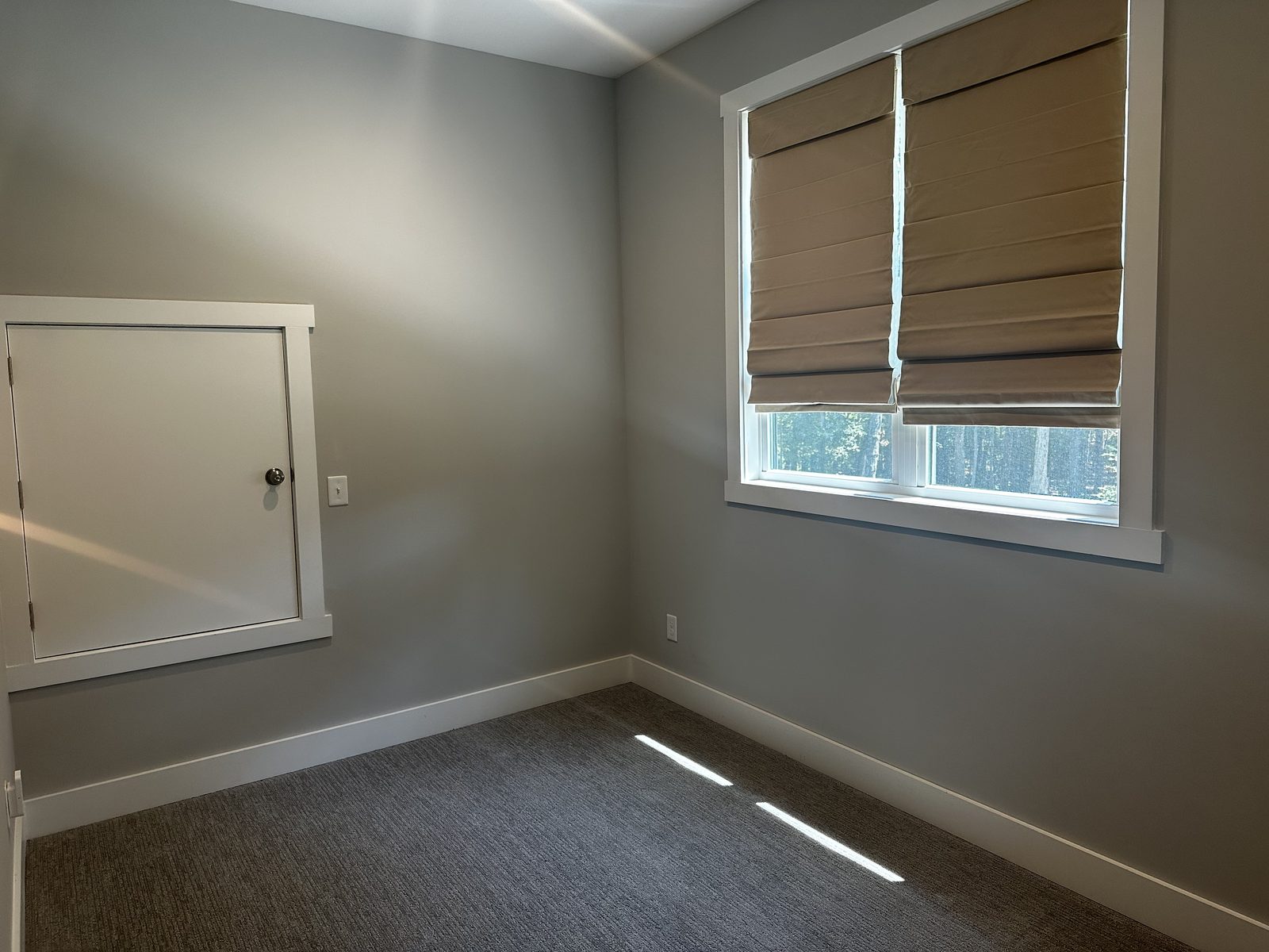 Bedroom painted in a warm greige tone with matching trim