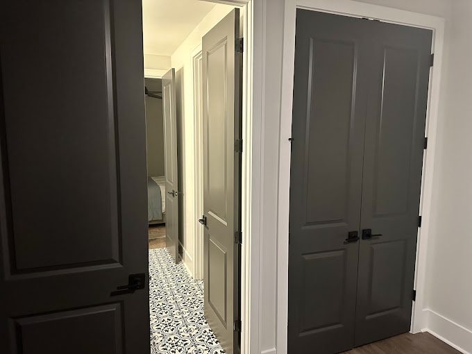 Interior doors painted in charcoal against lighter walls and trim