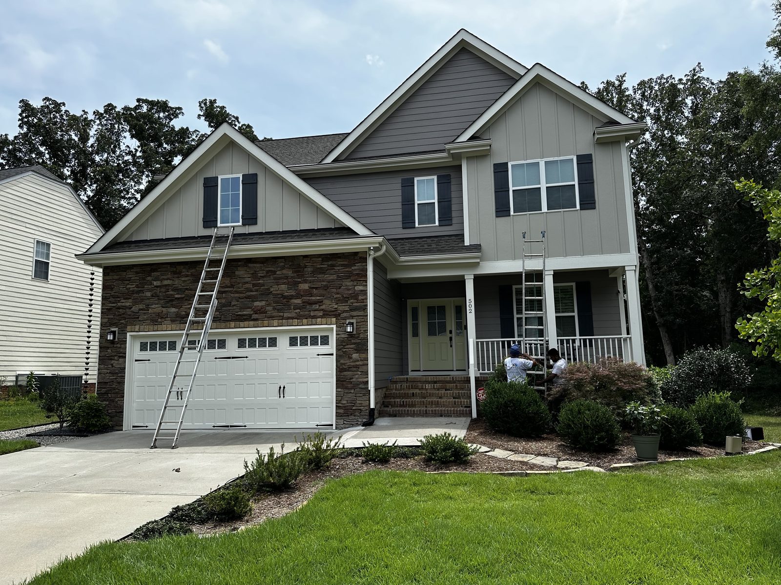 Gray siding with fresh white trim after an exterior repaint