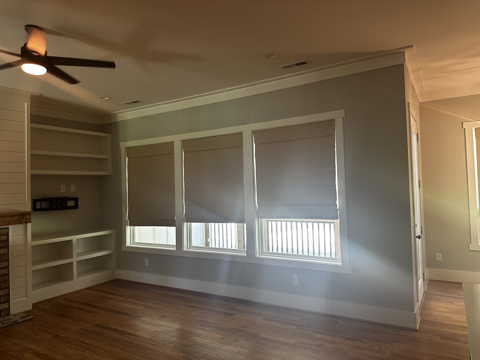 Living room with painted built-in shelving and soft green walls