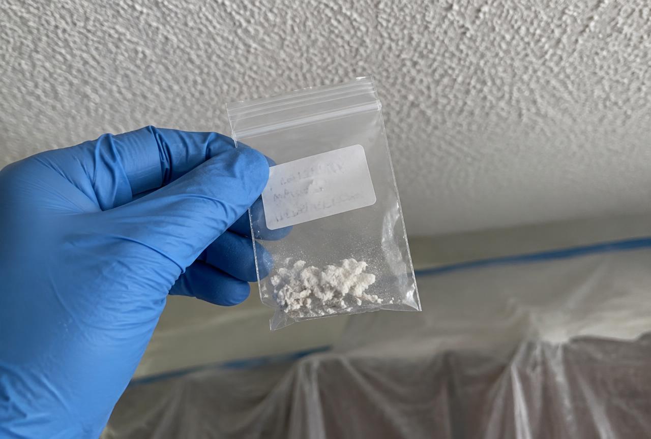 Sealed popcorn ceiling texture sample bagged for asbestos lab testing — Roca’s Painters, painters in Mebane, NC