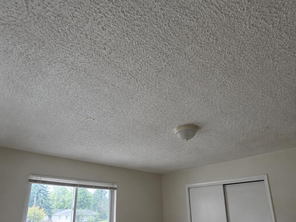 Dated popcorn ceiling texture before removal — popcorn ceiling removal by Roca’s Painters of Mebane, NC